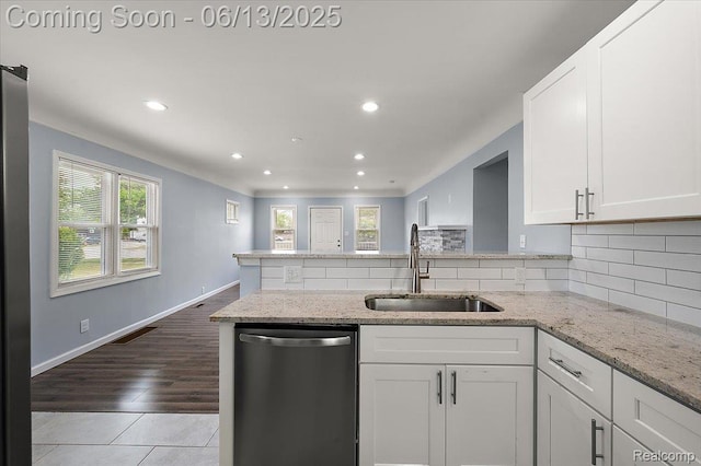 233 W 11 Mile Rd, Madison Heights, MI 48071 - kitchen featuring stainless steel dishwasher, healthy amount of natural light, white cabinets, and recessed lighting