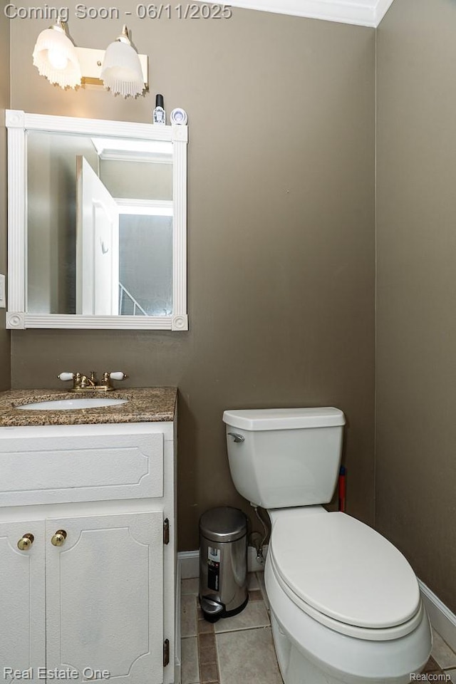 104 Manor Way Unit 1, Rochester Hills, MI 48309 - bathroom featuring toilet, vanity, baseboards, and tile patterned flooring