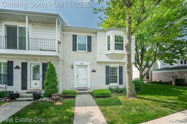 104 Manor Way Unit 1, Rochester Hills, MI 48309 - view of property with a front lawn and brick siding
