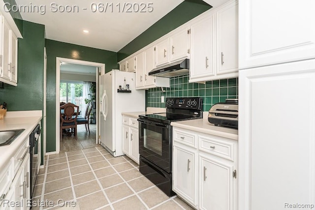104 Manor Way Unit 1, Rochester Hills, MI 48309 - kitchen with under cabinet range hood, black / electric stove, white cabinets, white fridge with ice dispenser, and backsplash