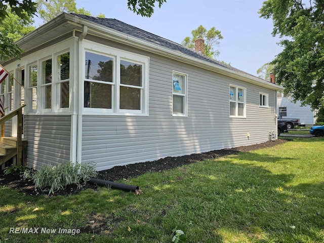 1902 Newberry St, Saginaw, MI 48602 - view of side of home with a chimney and a yard