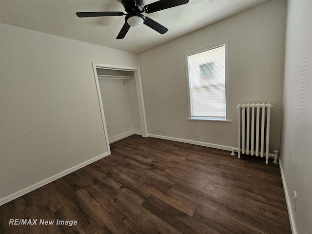 1902 Newberry St, Saginaw, MI 48602 - unfurnished bedroom featuring radiator, dark wood-type flooring, baseboards, and a closet
