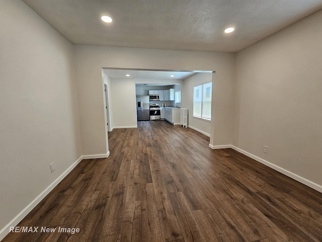 1902 Newberry St, Saginaw, MI 48602 - unfurnished living room with dark wood finished floors, baseboards, and recessed lighting
