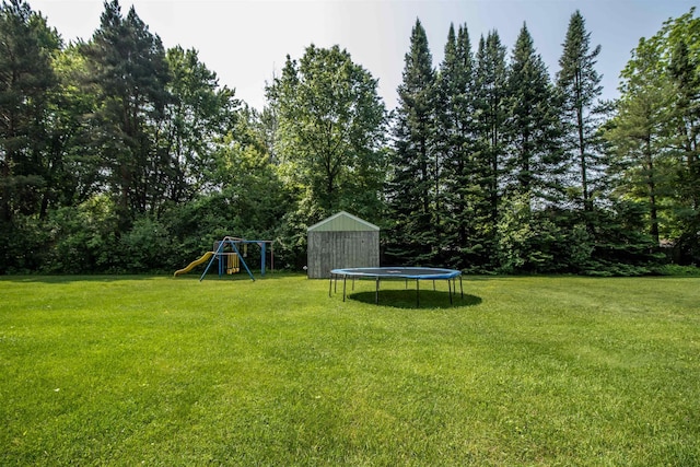 7070 Quain Rd, Birch Run, MI 48415 - view of grassy yard featuring a trampoline and a playground