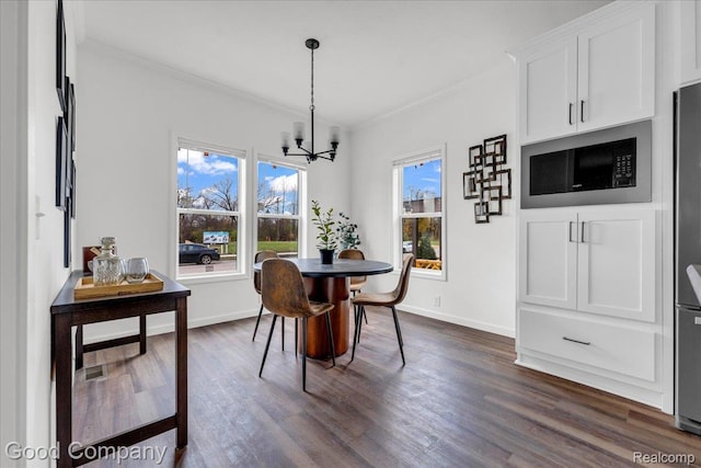 2826 16th St, Detroit, MI 48216 - dining area featuring dark wood-type flooring, a chandelier, and ornamental molding