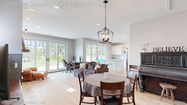 615 Dunleavy Dr, Highland, MI 48356 - dining room with light wood finished floors, recessed lighting, a chandelier, and french doors