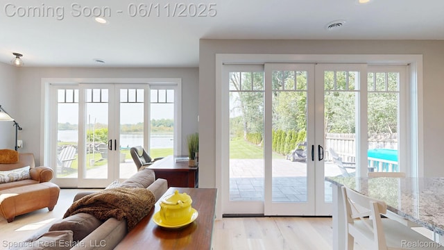 615 Dunleavy Dr, Highland, MI 48356 - entryway featuring french doors, recessed lighting, a water view, and light wood-type flooring