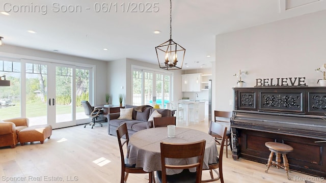 615 Dunleavy Dr, Highland, MI 48356 - dining area with light wood finished floors, plenty of natural light, a chandelier, and recessed lighting