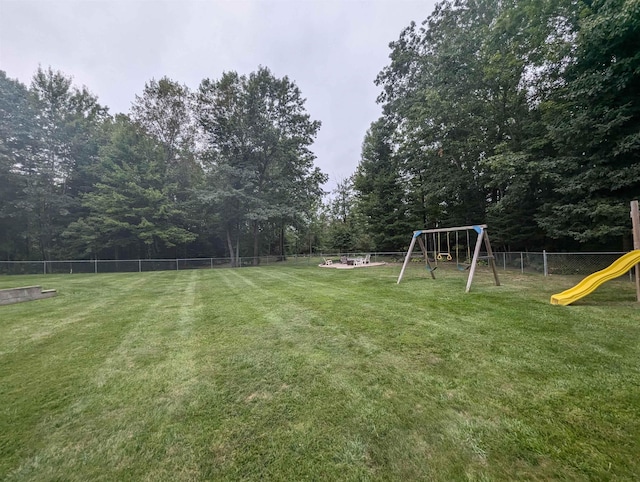 8544 Esmond Rd, Hale, MI 48739 - fenced backyard featuring a playground