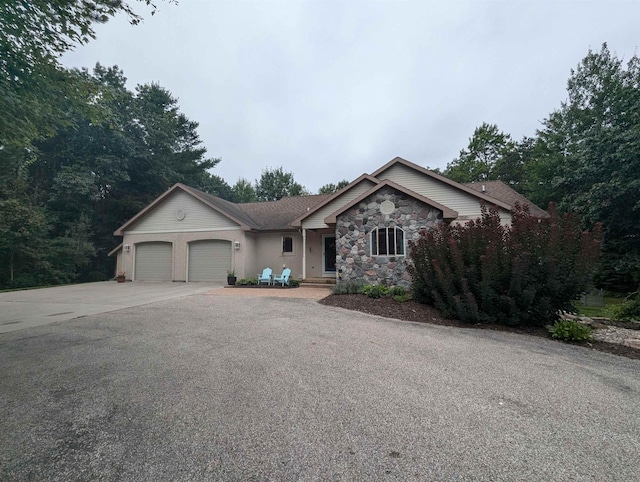 8544 Esmond Rd, Hale, MI 48739 - ranch-style home with a garage, driveway, and stone siding