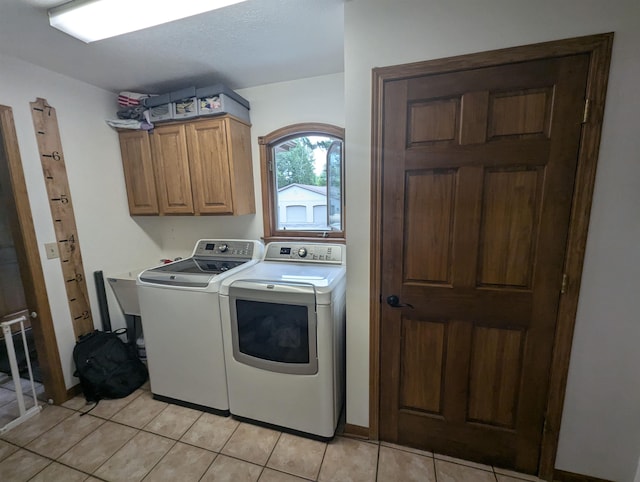 8544 Esmond Rd, Hale, MI 48739 - laundry room featuring independent washer and dryer, cabinet space, and light tile patterned floors