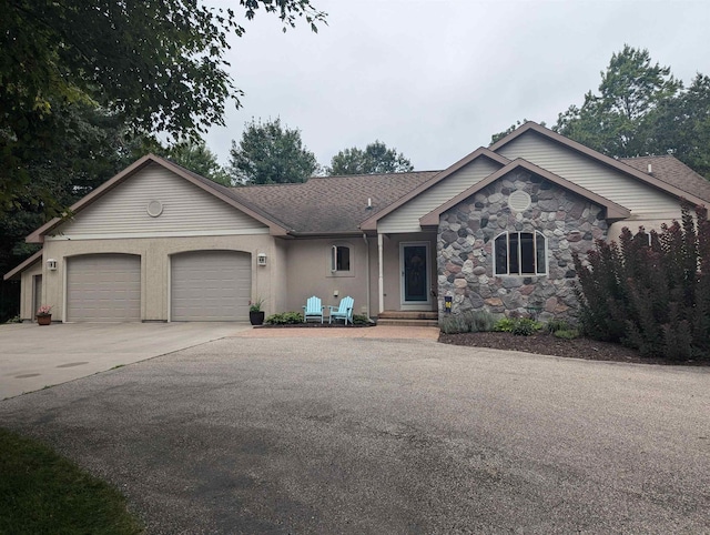 8544 Esmond Rd, Hale, MI 48739 - ranch-style home with driveway, a garage, and stone siding