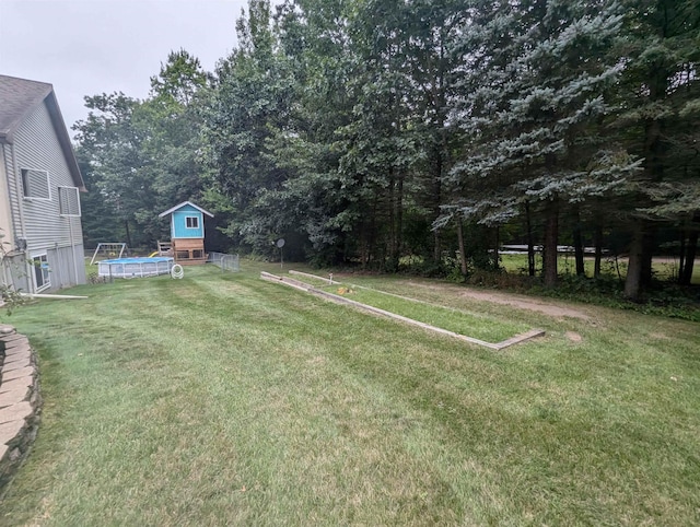 8544 Esmond Rd, Hale, MI 48739 - view of green lawn with an outdoor pool