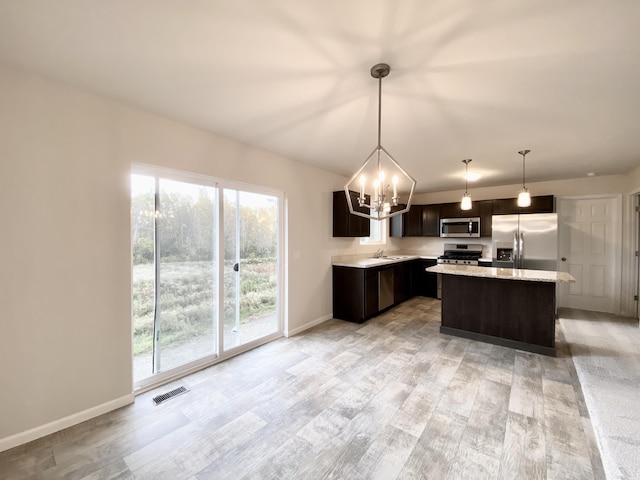 4272 Butternut Dr, Wayland, MI 49348 - kitchen featuring stainless steel appliances, a chandelier, light wood-style flooring, dark brown cabinetry, and baseboards