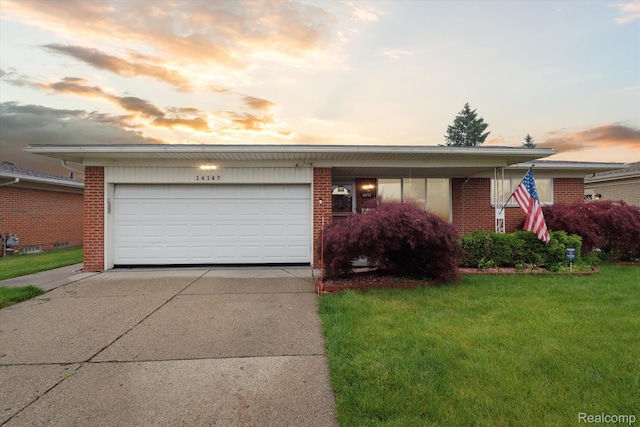 14147 Ivanhoe Dr, Warren, MI 48088 - view of front of property featuring concrete driveway, brick siding, a lawn, and a garage