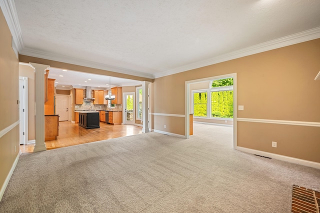 3265 Estates Dr, Saint Joseph, MI 49085 - unfurnished living room featuring ornate columns, ornamental molding, baseboards, light colored carpet, and a textured ceiling