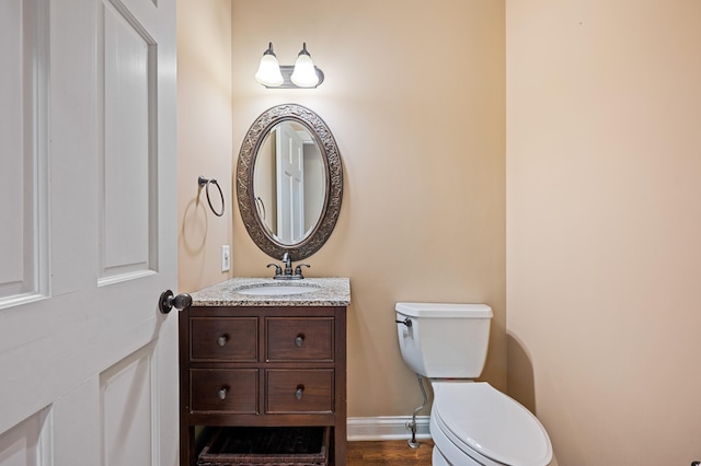 3265 Estates Dr, Saint Joseph, MI 49085 - half bath featuring toilet, vanity, and wood finished floors