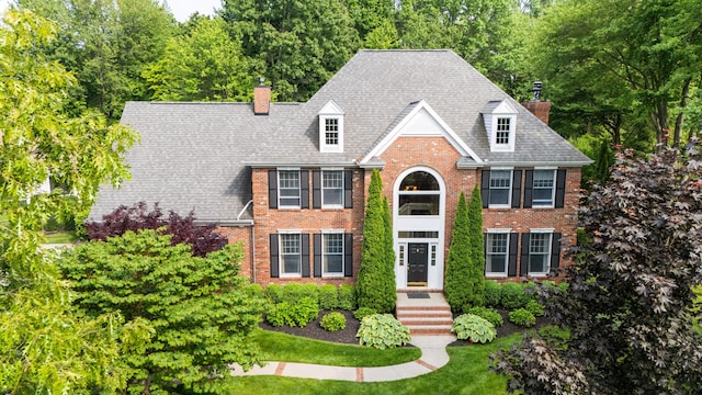 3265 Estates Dr, Saint Joseph, MI 49085 - view of front facade featuring a chimney and brick siding