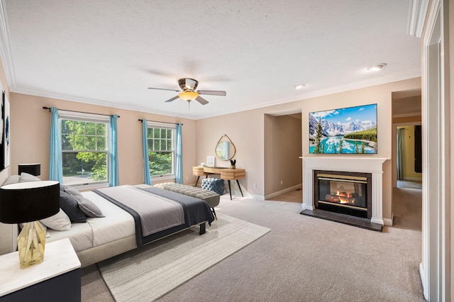 3265 Estates Dr, Saint Joseph, MI 49085 - carpeted bedroom featuring a glass covered fireplace, crown molding, baseboards, and ceiling fan