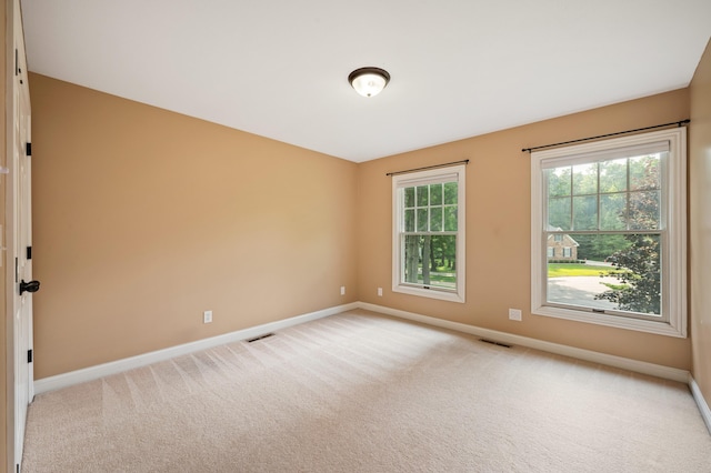 3265 Estates Dr, Saint Joseph, MI 49085 - spare room with baseboards and light carpet