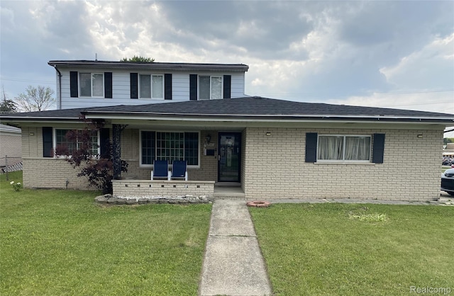 30347 Dell Ln, Warren, MI 48092 - view of front of property with covered porch, a front yard, and brick siding