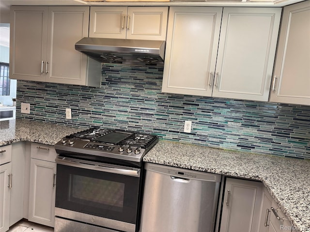 30347 Dell Ln, Warren, MI 48092 - kitchen with appliances with stainless steel finishes, exhaust hood, backsplash, and light stone counters