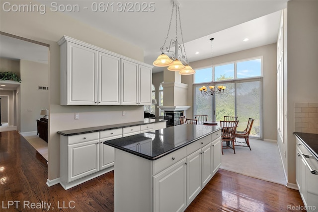 13815 Silent Woods Dr, Shelby Twp, MI 48315 - kitchen with dark countertops, a chandelier, a center island, white cabinets, and dark wood-style floors