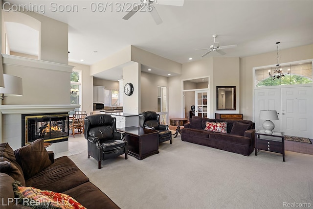 13815 Silent Woods Dr, Shelby Twp, MI 48315 - living area featuring ceiling fan, light colored carpet, recessed lighting, a multi sided fireplace, and a chandelier