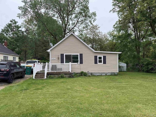 227 Mckinley Rd, Flushing, MI 48433 - view of front of house featuring a wooden deck and a front yard