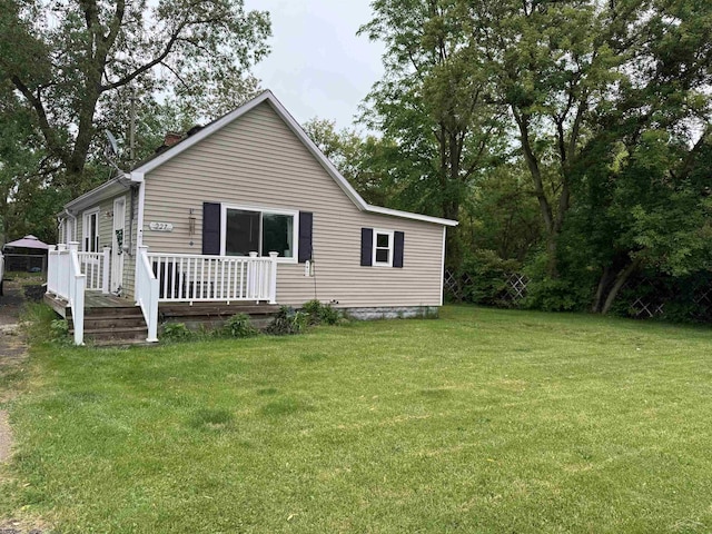 227 Mckinley Rd, Flushing, MI 48433 - back of property featuring a yard, a wooden deck, and a chimney
