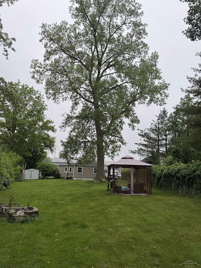 227 Mckinley Rd, Flushing, MI 48433 - view of green lawn featuring a gazebo and a fire pit