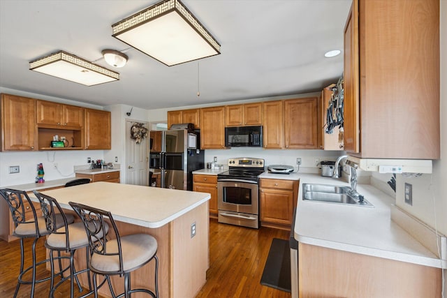 6819 Lakeway St, Ypsilanti, MI 48197 - kitchen with stainless steel range with electric cooktop, black microwave, refrigerator with ice dispenser, a sink, and light countertops