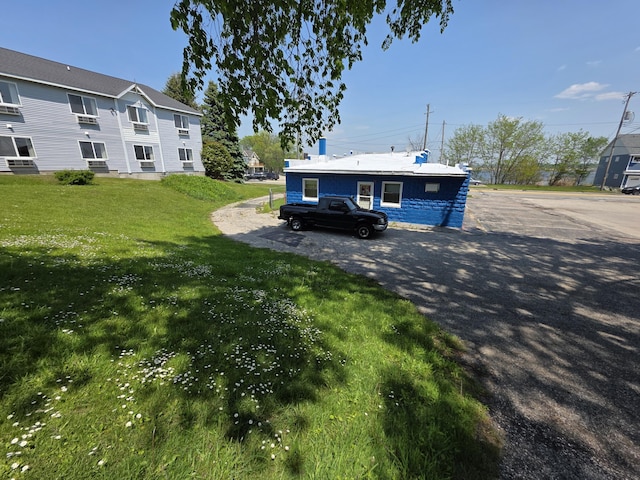 214 Arthur St, Manistee, MI 49660 - rear view of property with a yard