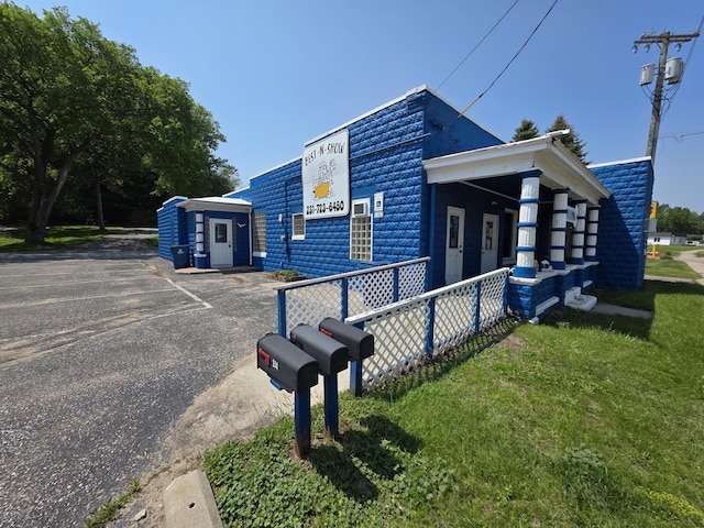 214 Arthur St, Manistee, MI 49660 - view of property exterior with uncovered parking