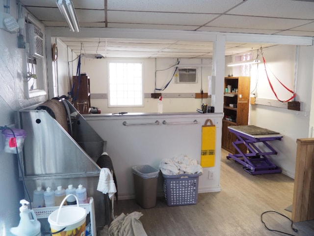214 Arthur St, Manistee, MI 49660 - misc room with wood finished floors, an AC wall unit, and baseboards