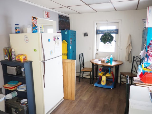 214 Arthur St, Manistee, MI 49660 - kitchen featuring freestanding refrigerator, wood finished floors, and a drop ceiling