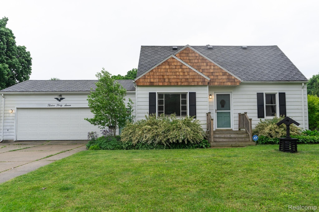 1247 Catalina Dr, Flint, MI 48507 - view of front of house with an attached garage, concrete driveway, a front yard, roof with shingles, and entry steps