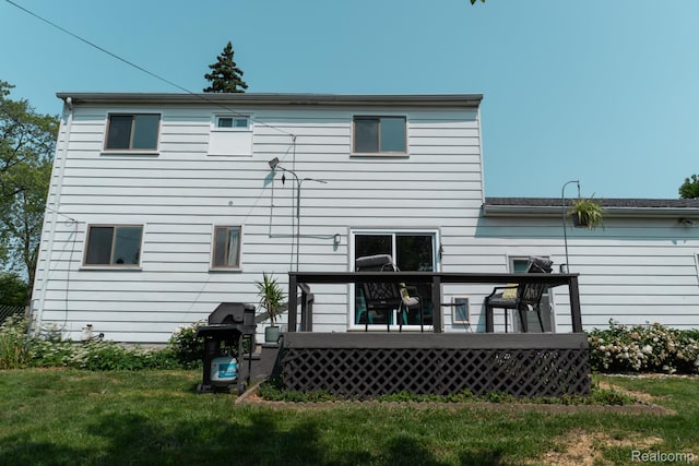 1247 Catalina Dr, Flint, MI 48507 - rear view of house with a deck and a yard