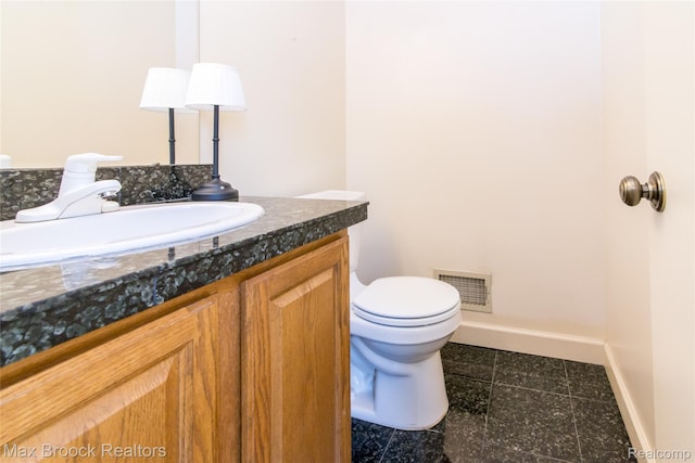 41350 Woodward Ave, Bloomfield Hills, MI 48304 - bathroom featuring toilet, vanity, and baseboards