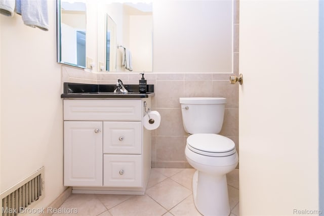 41350 Woodward Ave, Bloomfield Hills, MI 48304 - half bathroom featuring vanity, toilet, tile patterned flooring, and tile walls