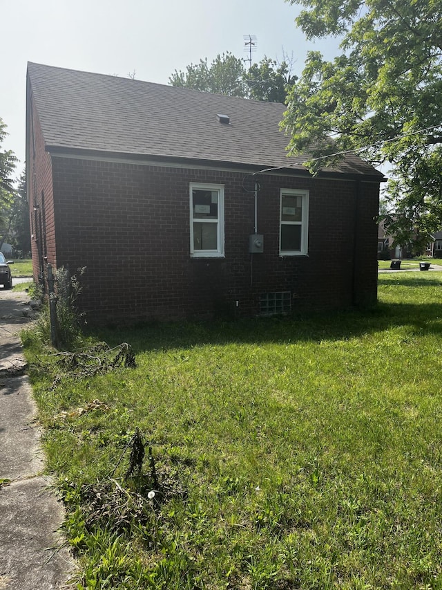 19188 Pelkey St, Detroit, MI 48205 - view of property exterior with roof with shingles, a lawn, and brick siding