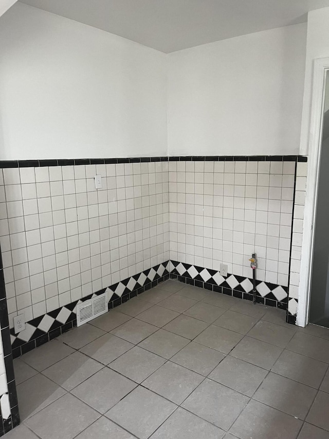 19188 Pelkey St, Detroit, MI 48205 - bathroom featuring tile walls, tile patterned floors, and a wainscoted wall