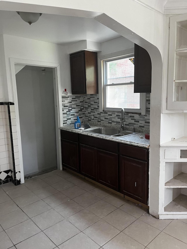 19188 Pelkey St, Detroit, MI 48205 - kitchen with a sink, light tile patterned flooring, light countertops, and decorative backsplash