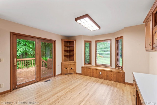 751 River Edge Ct, Flushing, MI 48433 - unfurnished dining area featuring light wood-type flooring and baseboards