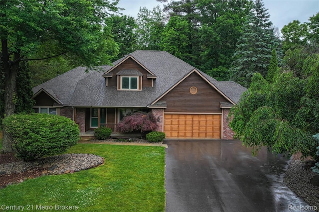 751 River Edge Ct, Flushing, MI 48433 - view of front of home with asphalt driveway, brick siding, a porch, and a garage