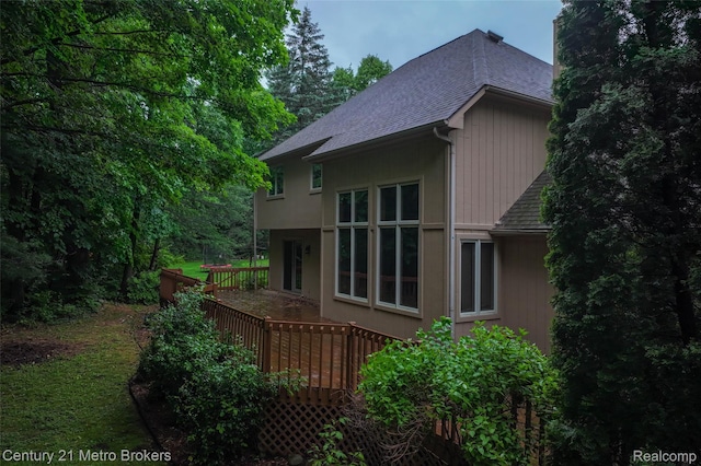 751 River Edge Ct, Flushing, MI 48433 - view of home's exterior featuring a shingled roof, a wooden deck, and a chimney