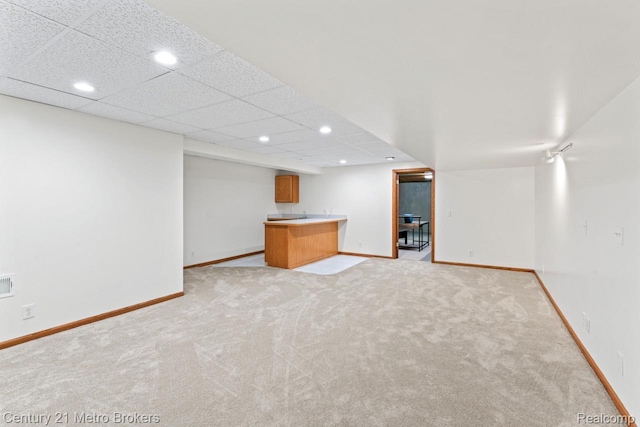 751 River Edge Ct, Flushing, MI 48433 - finished below grade area with recessed lighting, light colored carpet, bar with sink, and a drop ceiling