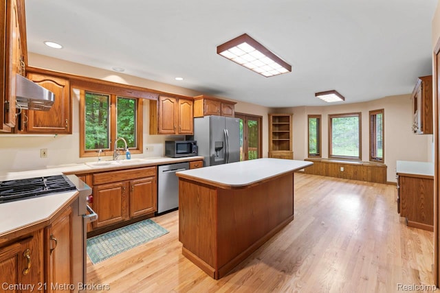 751 River Edge Ct, Flushing, MI 48433 - kitchen with stainless steel appliances, a center island, wall chimney exhaust hood, light countertops, and recessed lighting