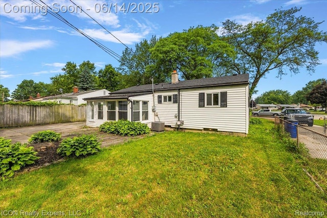 2570 Tarry Dr, Macomb, MI 48310 - rear view of house featuring a sunroom, a chimney, and crawl space