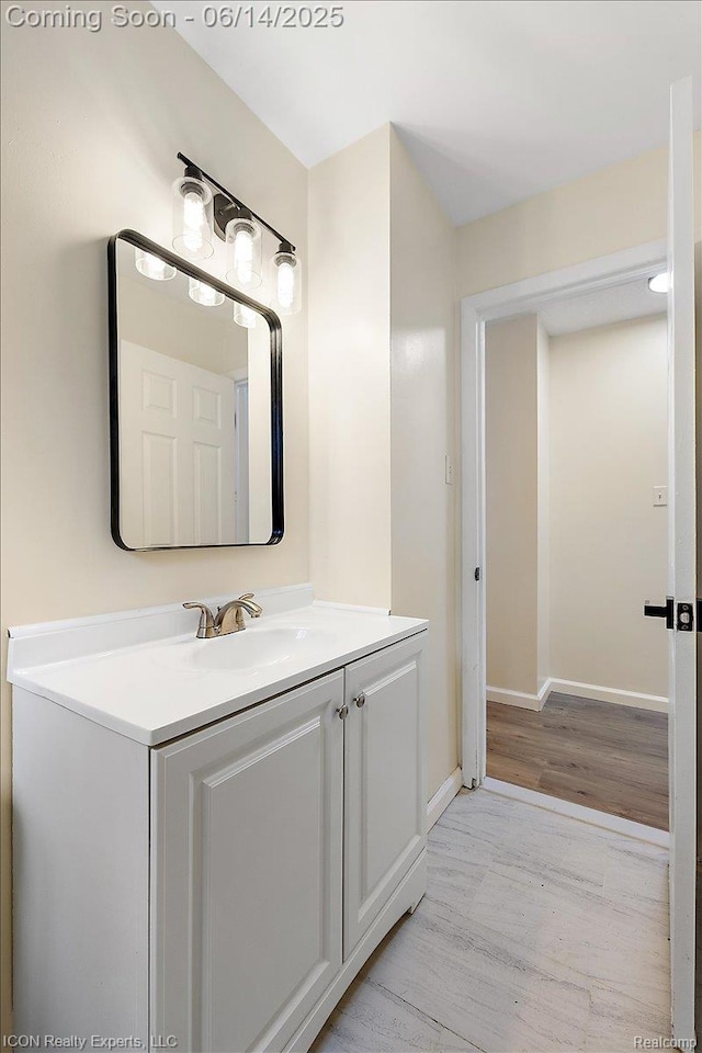 2570 Tarry Dr, Macomb, MI 48310 - bathroom featuring wood finished floors, vanity, and baseboards